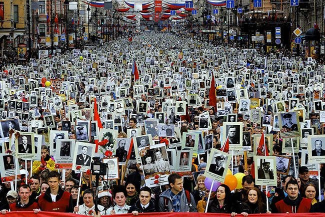 MAY 9: Local residents carry portraits of their relatives, participants in World War Two, as they celebrate Victory Day in St. Petersburg, Russia. About 30,000 people walked in the march called 'Immortal regiment.' Victory Day, marking the defeat of Nazi Germany, is Russia's most important secular holiday. (Dmitry Lovetsky/Associated Press)